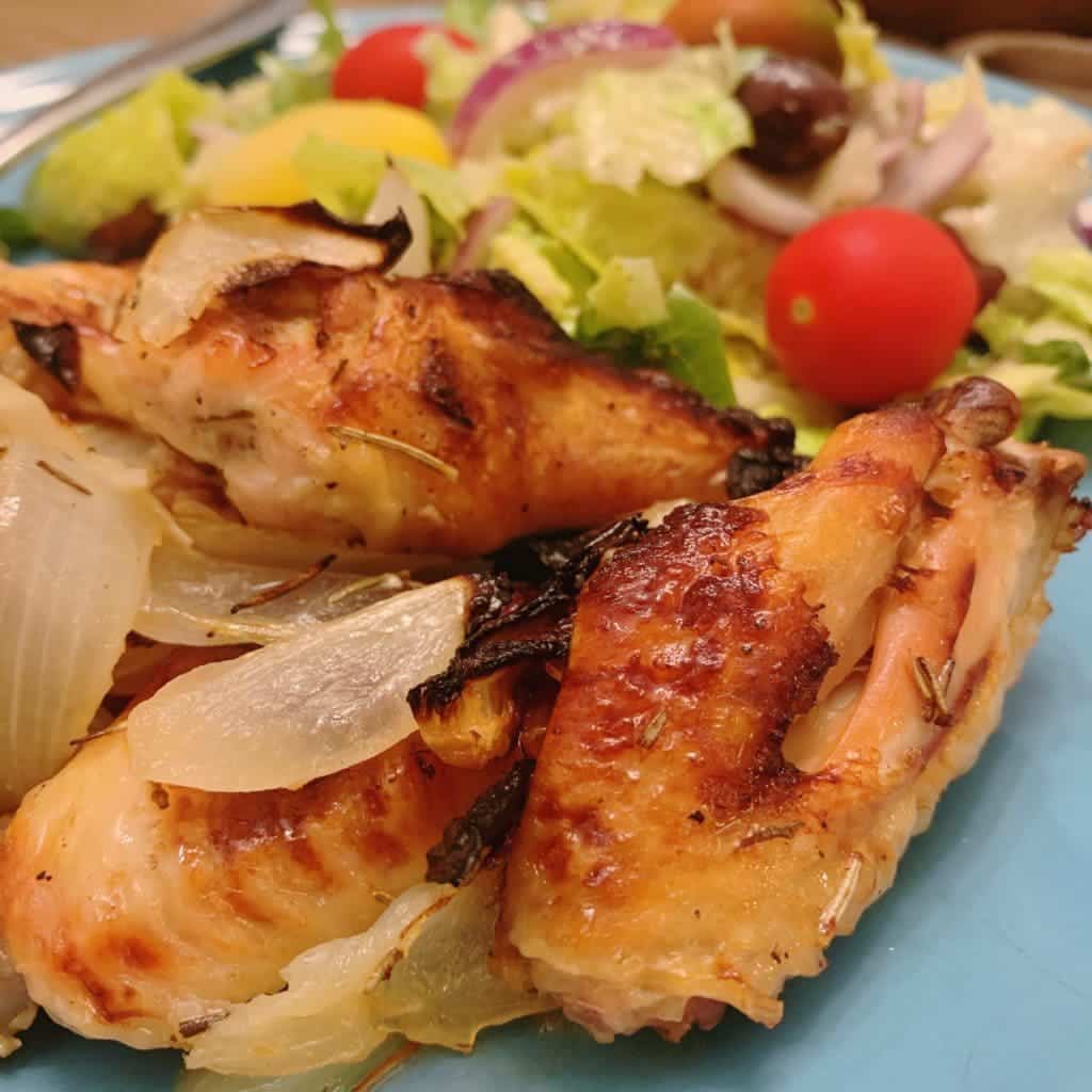 close up of plated chicken wings and salad