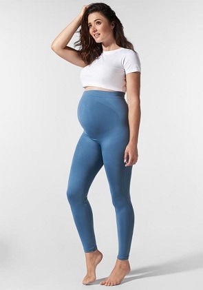 maternity leggings a pregnant woman wearing a white crop top and blue over belly leggings