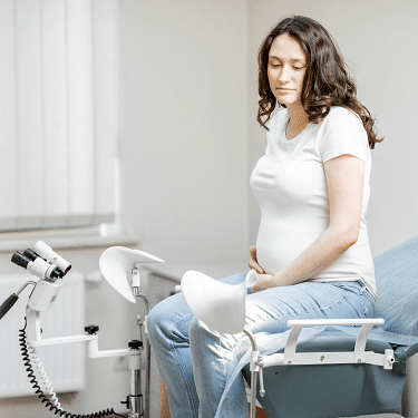 placenta previa a pregnant woman sitting on an exam table