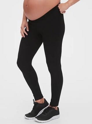 maternity leggings a pregnant woman wearing balck leggings and black tennis shoes