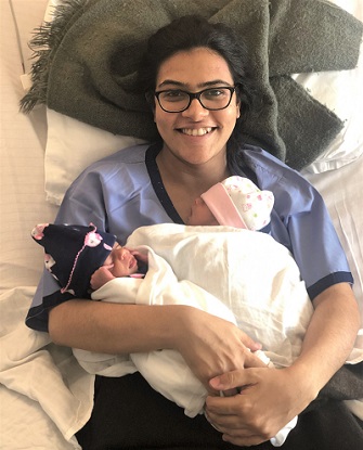 a woman holding her newborn twins 