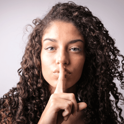 surviving divorce a woman making a shh sign with her finger to her lips