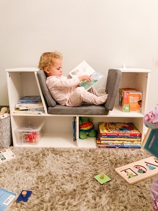 destructive kids a toddler reading a book in a playroom