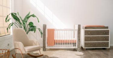 baby's room with crib, dresser, and rocker