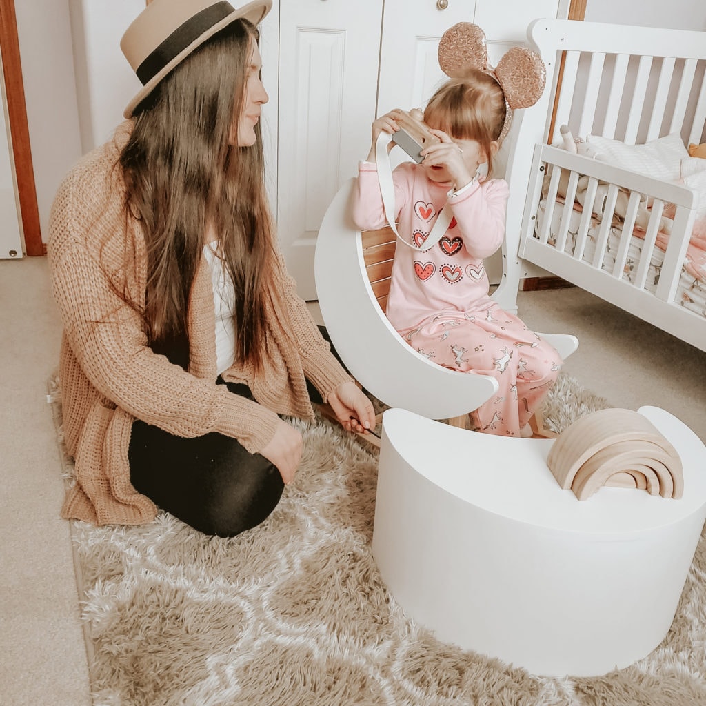 mom with little girl sitting on a child rocking chair