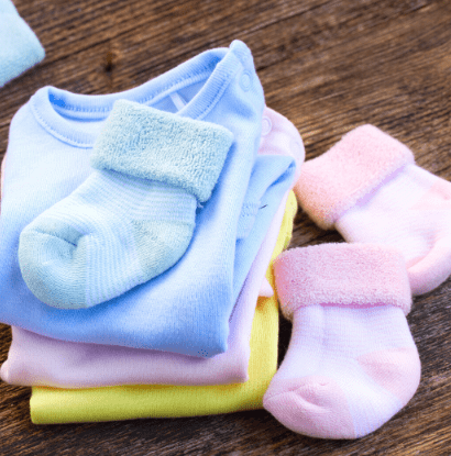 pink baby socks with blue socks and baby onsies