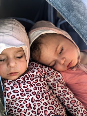 two toddlers sleeping against one another