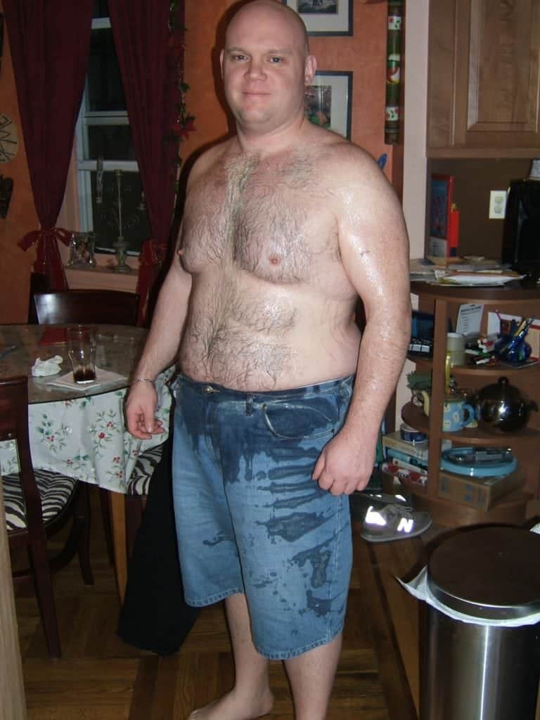 man with no shirt and covered in spit up