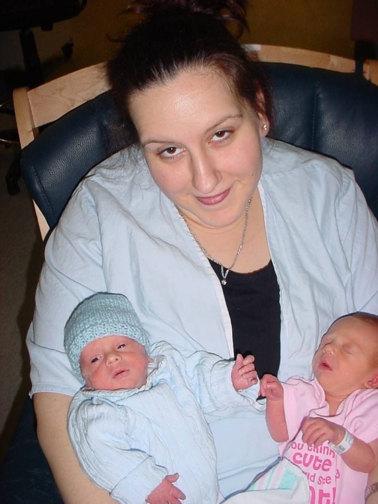 mom and infant twins sitting in a rocking chair