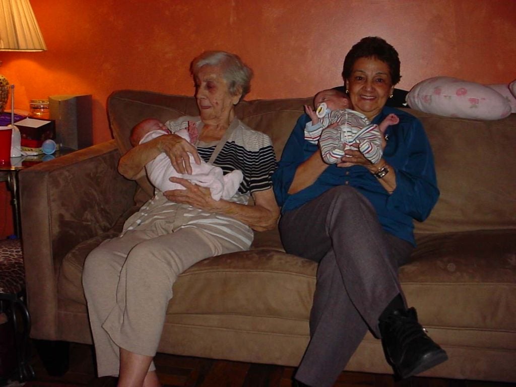 two grandmas holding twins