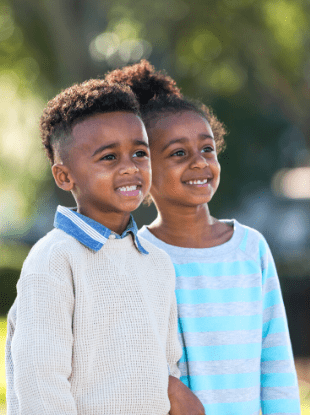 boy girl twins standing together outside