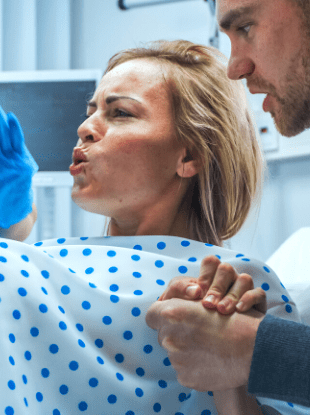 a man holding a woman's hand while she is in labor