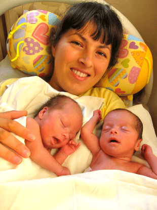 a woman holding newborn twins