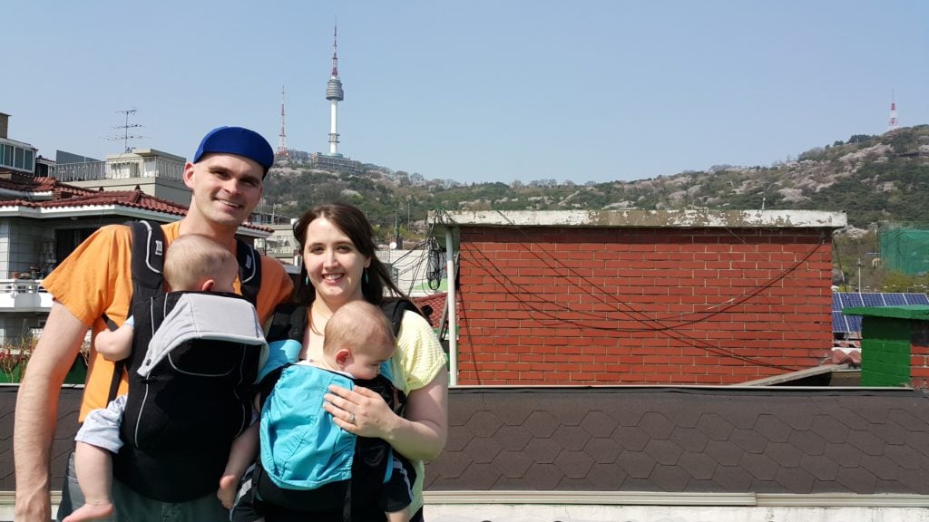 A family standing outside with the couple wearing their twins