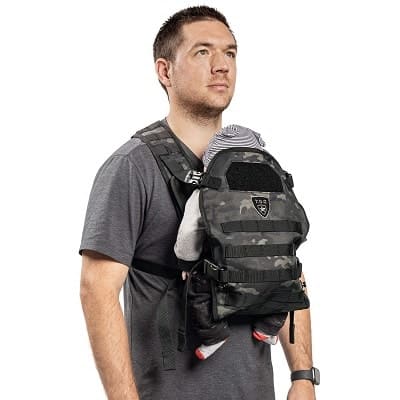 a man using a front baby carrier, hands free