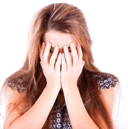 stressed out mom holding her head on her hands