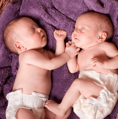 infant twins sleeping together