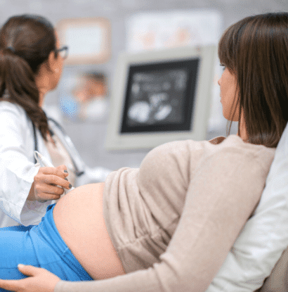 doctor looking at pregnant woman ultrasound screen