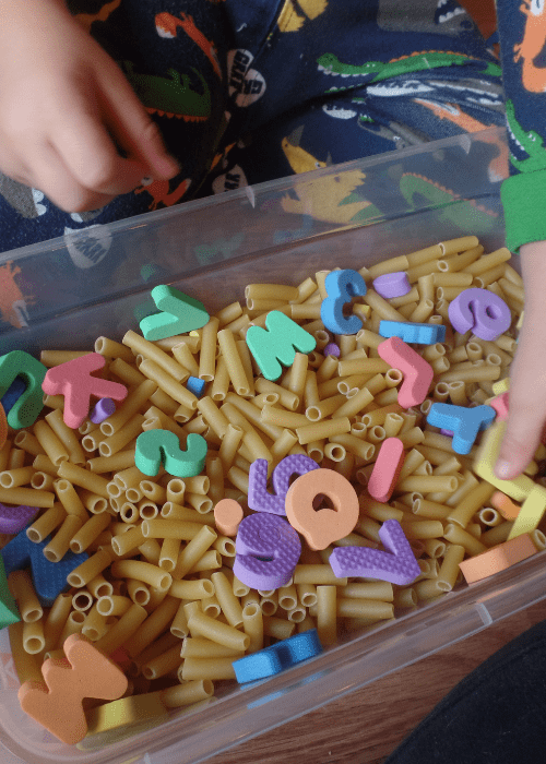 bin with dry noodles and foam letters