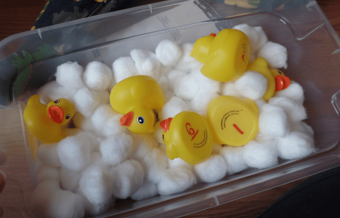 bin with cotton balls and rubber ducks