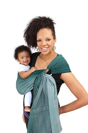a woman holding a baby in a ring sling carrier, both smiling