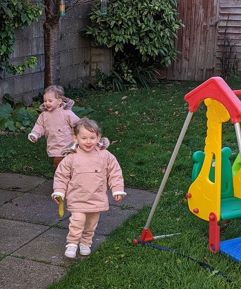 twin girls running outside