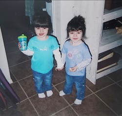 di di identical twin girls holding hands