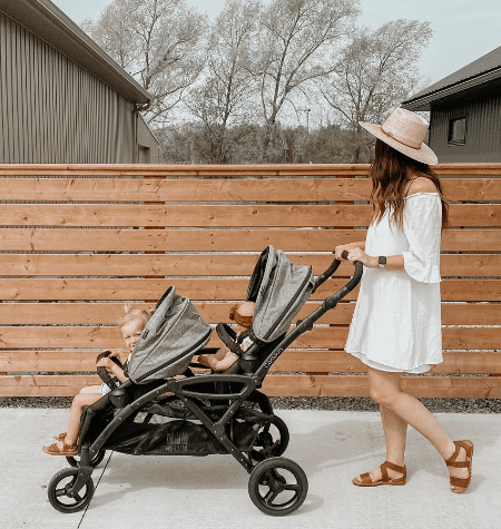 woman pushing twins in double stroller
