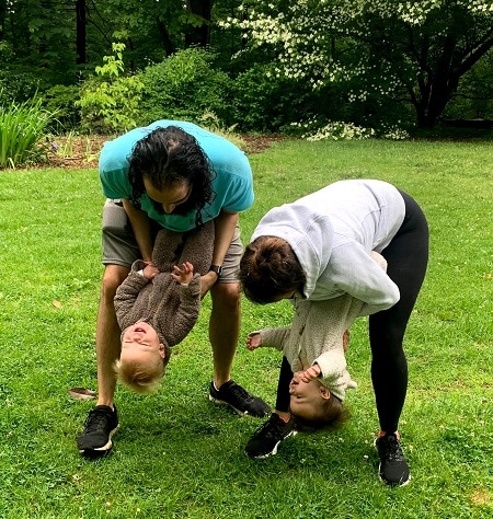 a couple playing with twins upside down