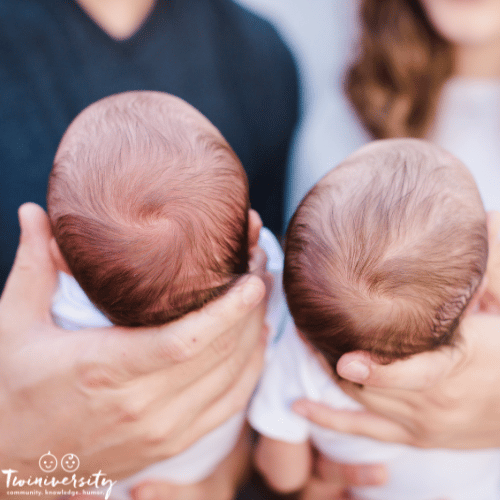 a close-up shot of a couple holding their di-di twins