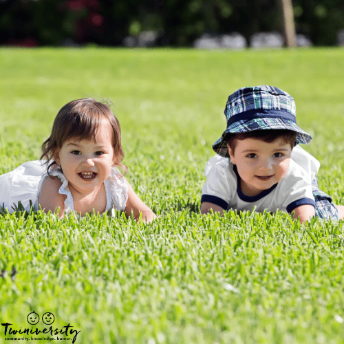 di-di twin toddlers outside on grass