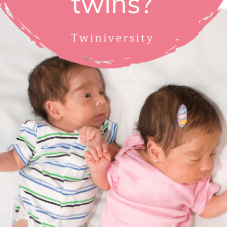 infant twin babies laying on a bed