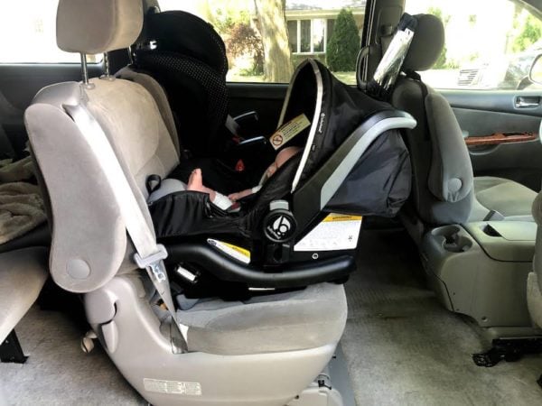 interior of a minivan with two car seats installed in the middle row