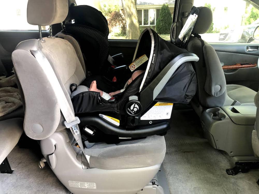 interior of a minivan with two car seats installed in the middle row