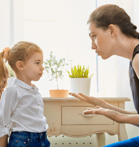 mom disciplining young girl