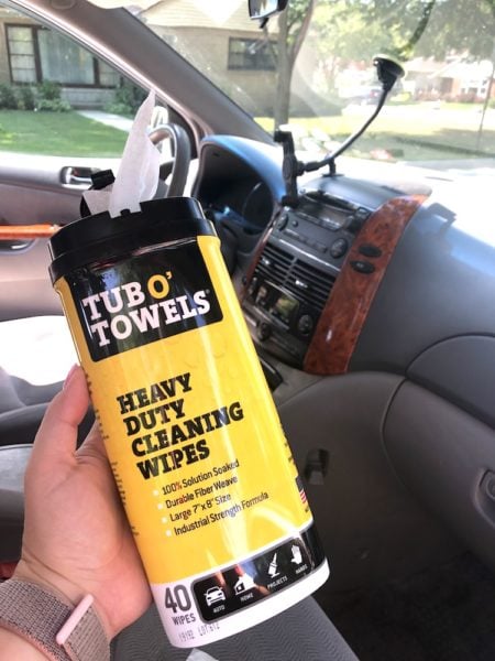 a box of tub o towels wipes and the dashboard of a minivan