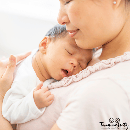 a mother and her newborn baby cuddle