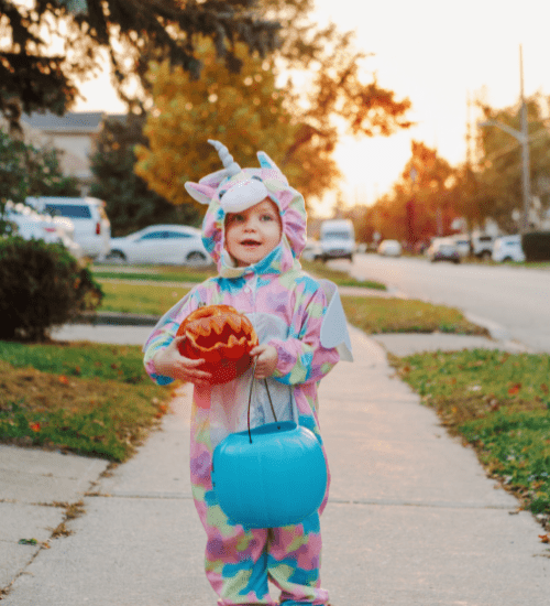 little kid trick or treating on halloween with toddlers