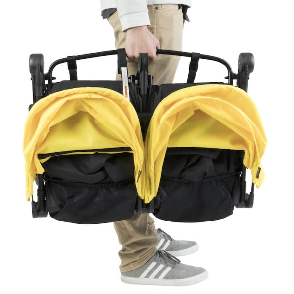 man holding a mountain buggy nano duo stroller
