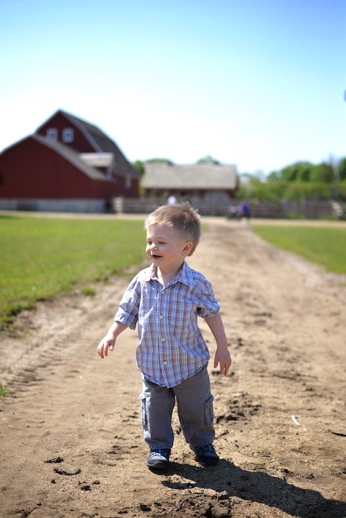 little boy running on the farm
