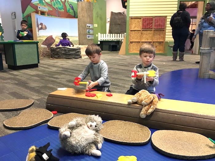 twin boys playing at a children's museum
