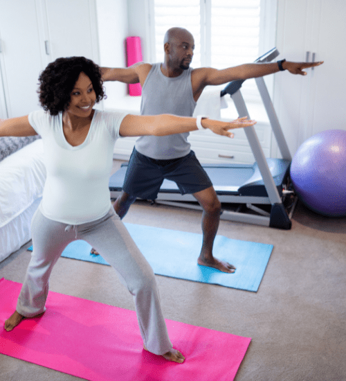 a couple stretching on yoga mats to beat holiday stress