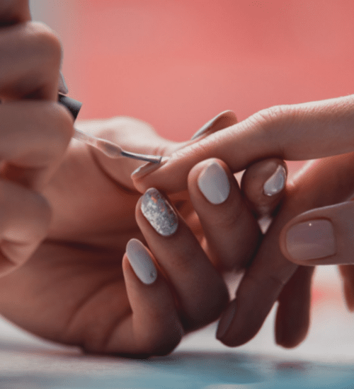 a hand getting a manicure to beat holiday stress