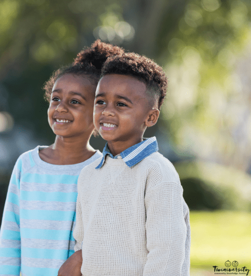 boy girl fraternal twins standing side by side outside posed and smiling for a photo