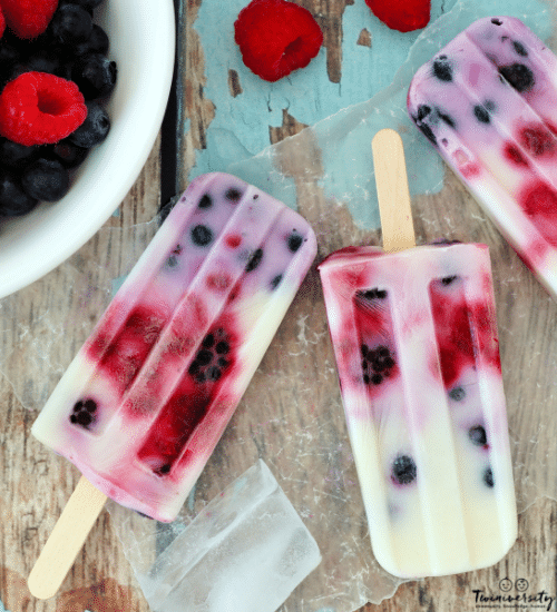 a bowl of fruit and popsicles on a piece of wax paper on top of a wood table for dysgeusia