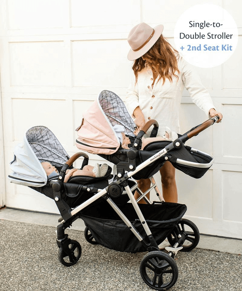 a woman with twins in their Mockingbird stroller seats