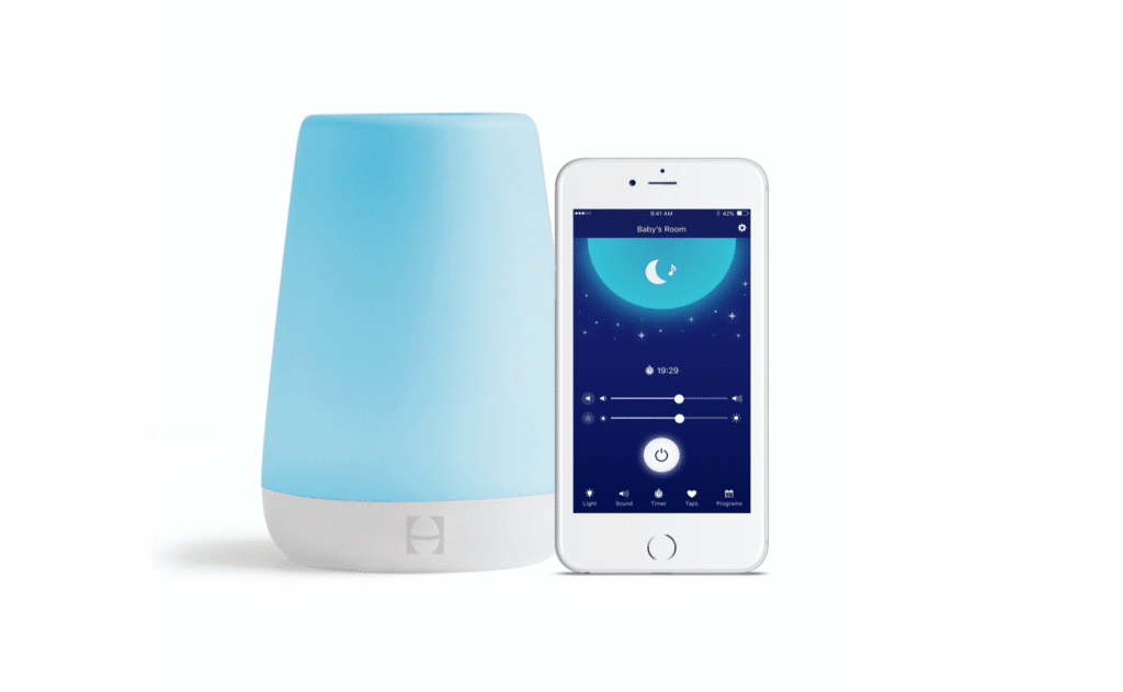 White noise machine with blue glowing light on left; white iphone with nighttime graphic on right