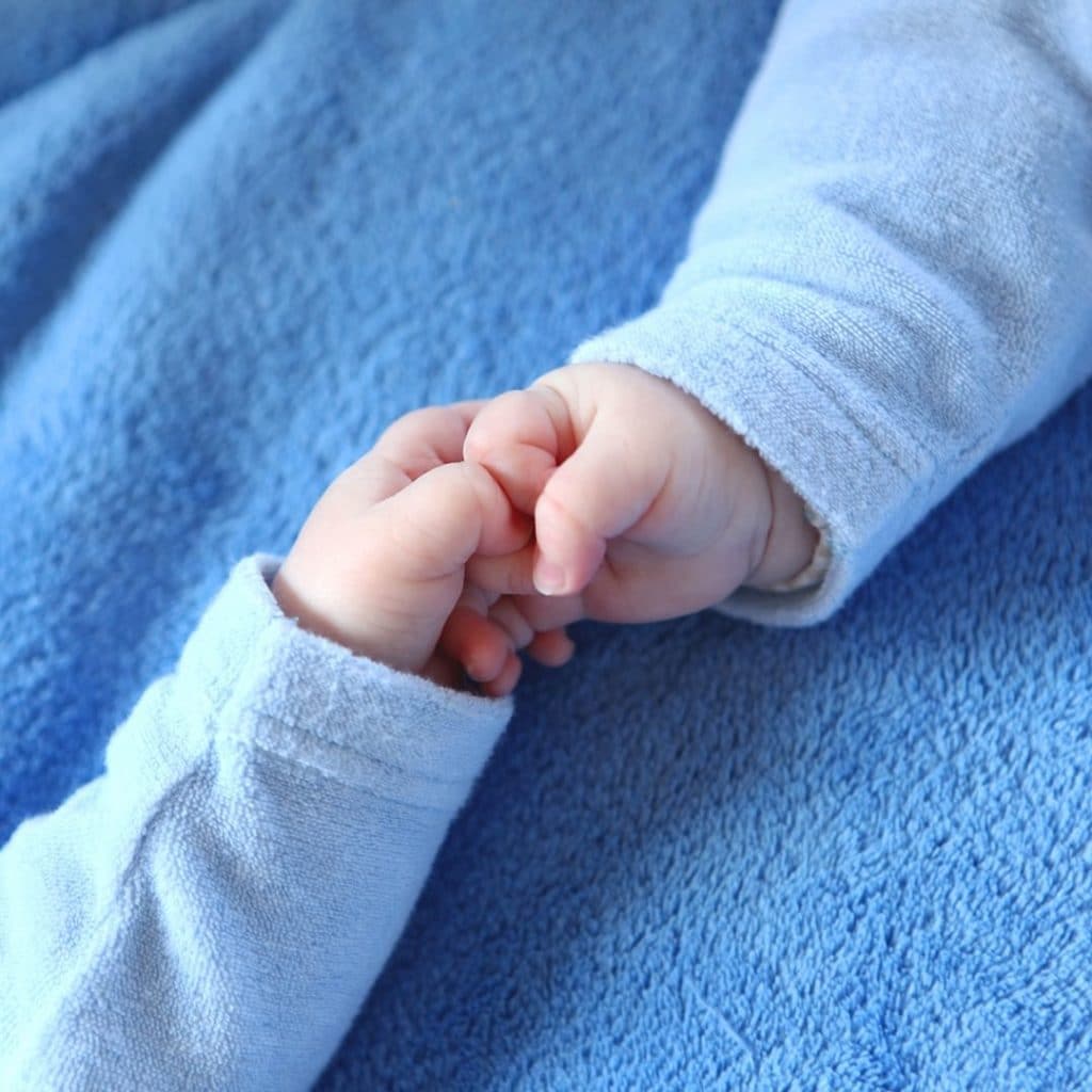 infant hands holding each other