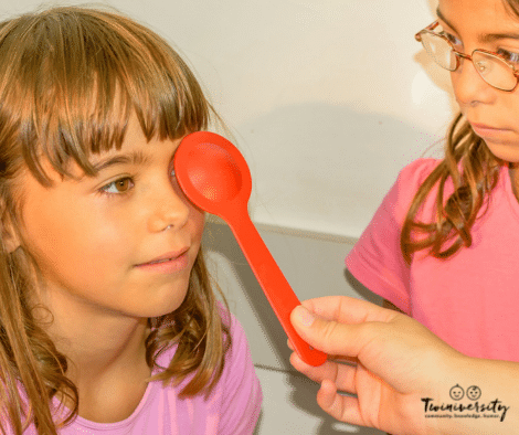 two girls being examined at pediatric eye doctor