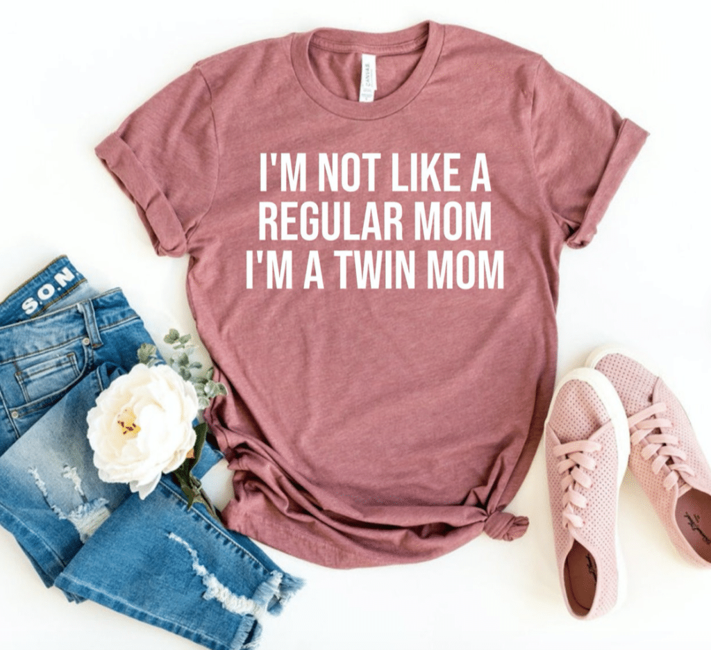 Pink tee shirt with white lettering reading "I'm not like a regular mom I'm a twin mom"